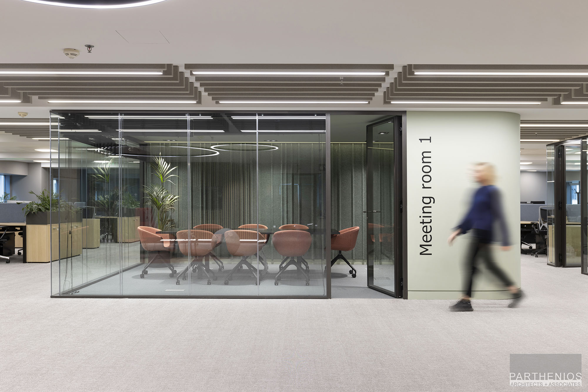 external view of meeting room with glass partitions at workspaces